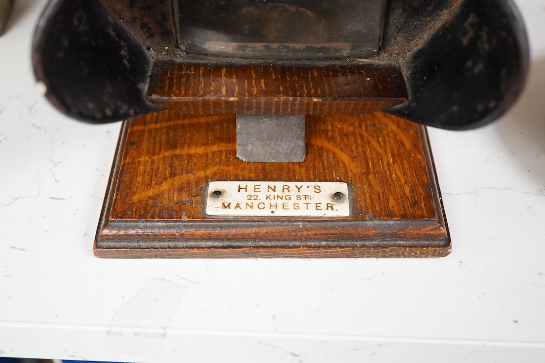 An early 20th century Kinora cinematographic viewer by Bond’s Ltd., 138 New Bond Street, c.1910, with six reels of flip card picture films, black painted steel and oak construction, with an ivory retail label for Henry’s